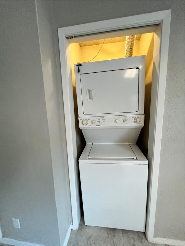 laundry room with stacked washer / dryer