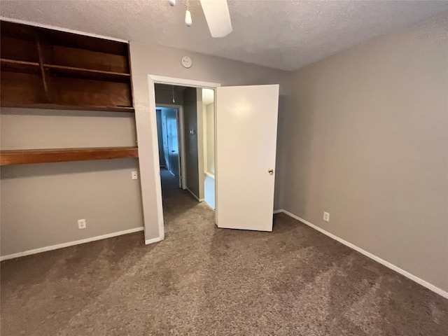 unfurnished bedroom with a ceiling fan, carpet, baseboards, and a textured ceiling