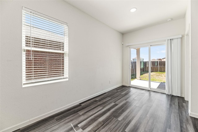 unfurnished room with dark wood finished floors, recessed lighting, and baseboards