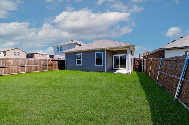 back of property featuring a lawn and a fenced backyard