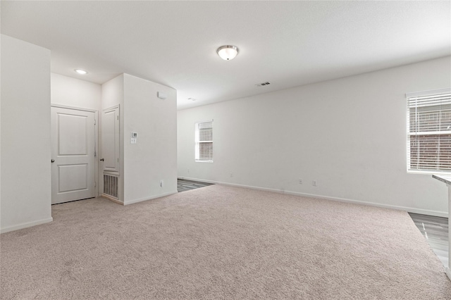 spare room featuring visible vents, recessed lighting, baseboards, and carpet floors