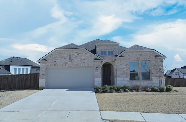 view of front of property featuring brick siding, a shingled roof, fence, a garage, and driveway