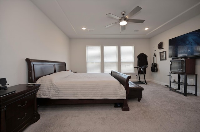 carpeted bedroom with a raised ceiling, recessed lighting, and baseboards