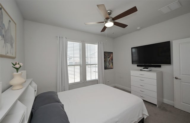 bedroom with baseboards, light colored carpet, visible vents, and ceiling fan