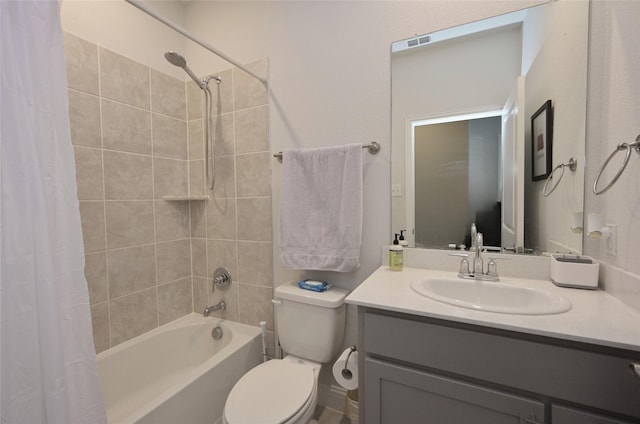 full bath with visible vents, toilet, vanity, and shower / bath combo