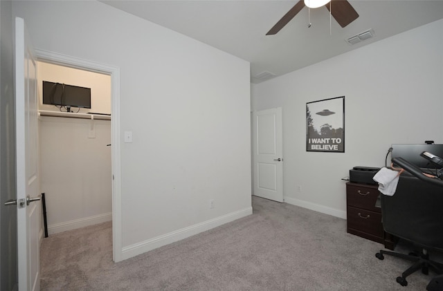 carpeted home office featuring baseboards, visible vents, and ceiling fan