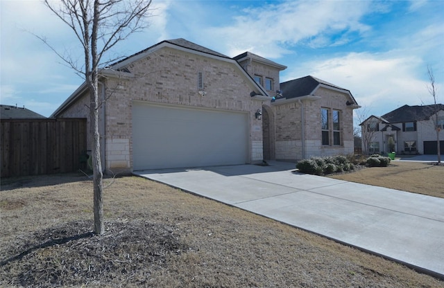 view of front of property featuring stone siding, fence, concrete driveway, a garage, and brick siding