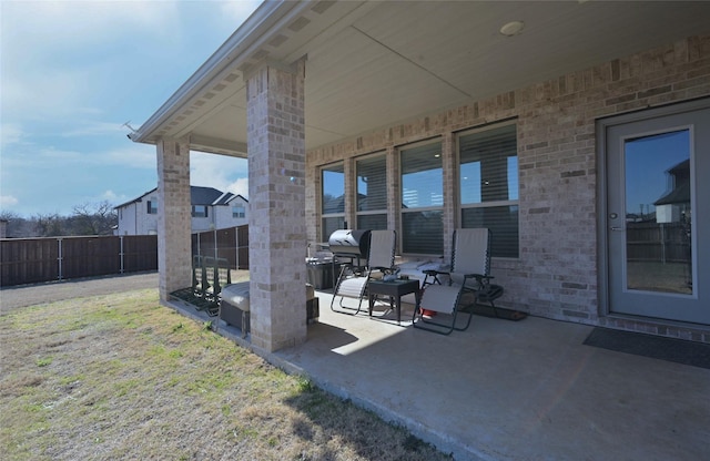 view of patio / terrace featuring fence and a grill