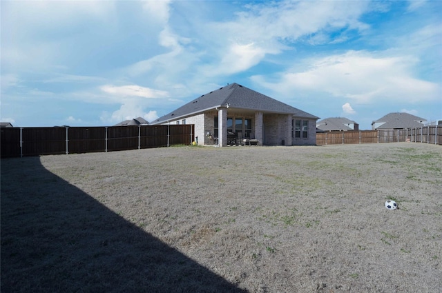 view of yard with a fenced backyard