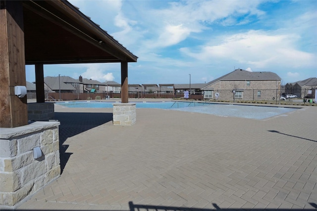 view of pool with a residential view and fence