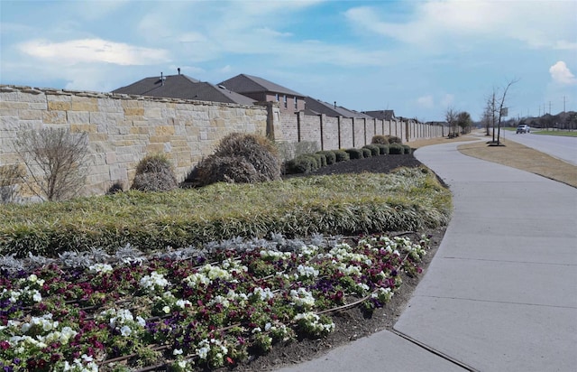 view of property's community featuring fence