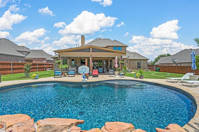 view of pool featuring a yard, a patio area, a fenced in pool, and a fenced backyard