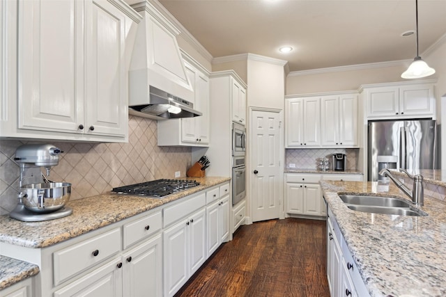 kitchen featuring ornamental molding, a sink, dark wood-style floors, white cabinetry, and stainless steel appliances