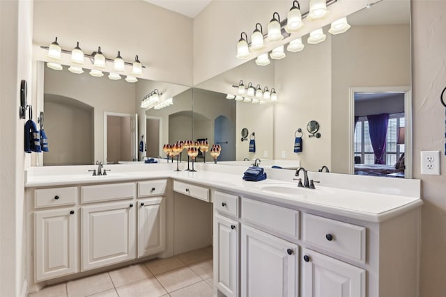 full bath with tile patterned flooring, double vanity, and a sink