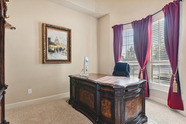 home office with light colored carpet and baseboards