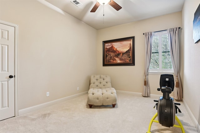 living area with visible vents, baseboards, a ceiling fan, and carpet flooring