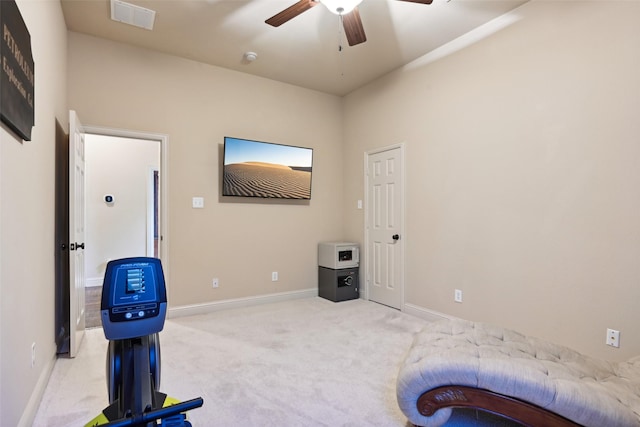 exercise area featuring carpet flooring, ceiling fan, baseboards, and visible vents