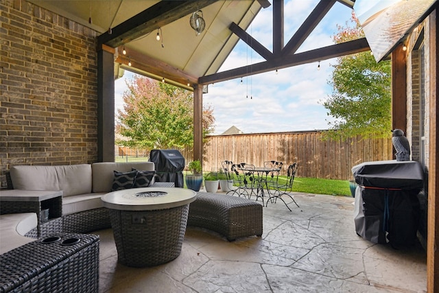 view of patio featuring a gazebo, a grill, an outdoor living space with a fire pit, and fence