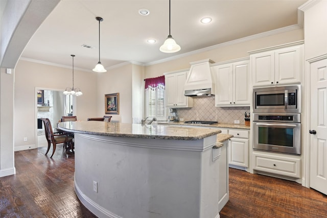 kitchen with premium range hood, arched walkways, ornamental molding, stainless steel appliances, and backsplash