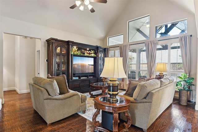 living area with dark wood finished floors, a ceiling fan, baseboards, and high vaulted ceiling