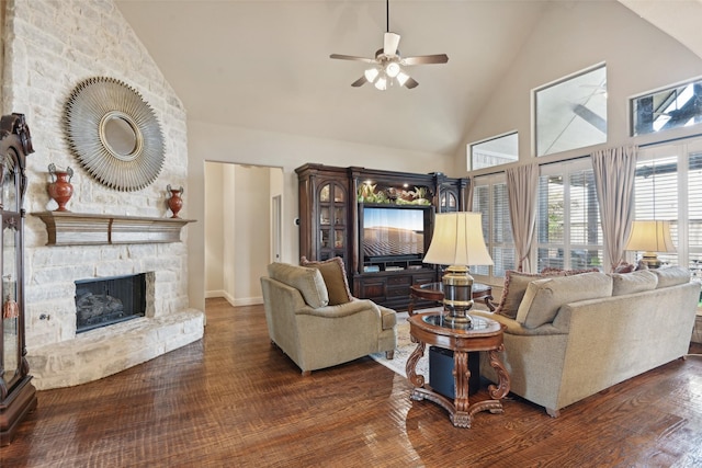 living area with ceiling fan, wood finished floors, a fireplace, and high vaulted ceiling