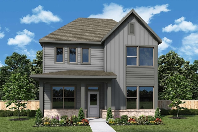 view of front facade with board and batten siding, a front yard, and fence