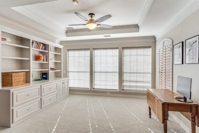 office with light carpet, visible vents, crown molding, and a raised ceiling