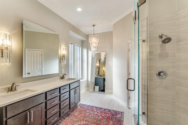 bathroom with a sink, baseboards, a stall shower, and crown molding