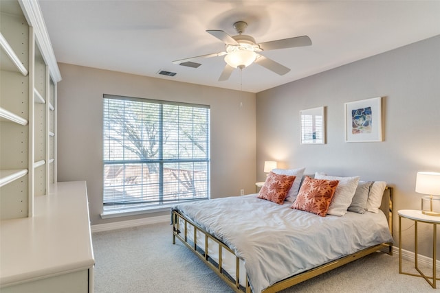 bedroom with visible vents, carpet floors, baseboards, and a ceiling fan