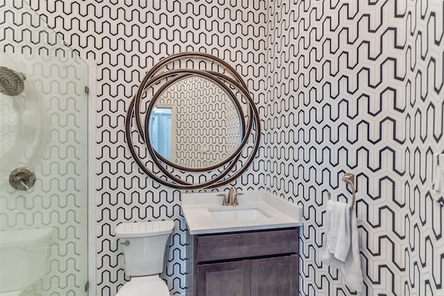 full bathroom featuring tile walls, toilet, vanity, and walk in shower