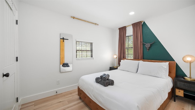 bedroom featuring recessed lighting, baseboards, and wood finished floors
