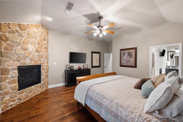 bedroom featuring visible vents, wood finished floors, and vaulted ceiling