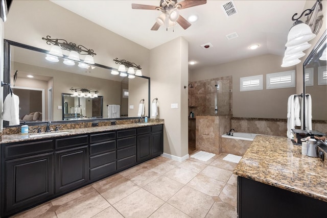 bathroom featuring a ceiling fan, visible vents, double vanity, a sink, and tile patterned floors