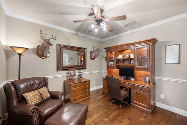 office with visible vents, ceiling fan, dark wood-style flooring, and crown molding