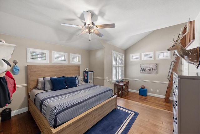 bedroom featuring hardwood / wood-style flooring, baseboards, lofted ceiling, and ceiling fan