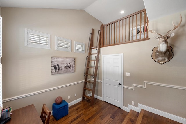 stairway featuring recessed lighting, baseboards, lofted ceiling, and wood finished floors