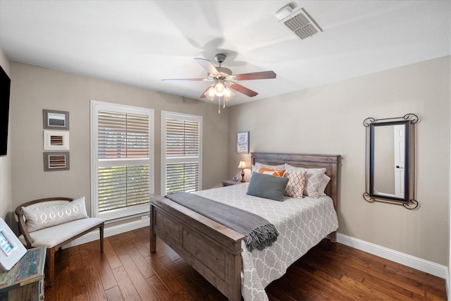 bedroom with visible vents, a ceiling fan, baseboards, and hardwood / wood-style flooring