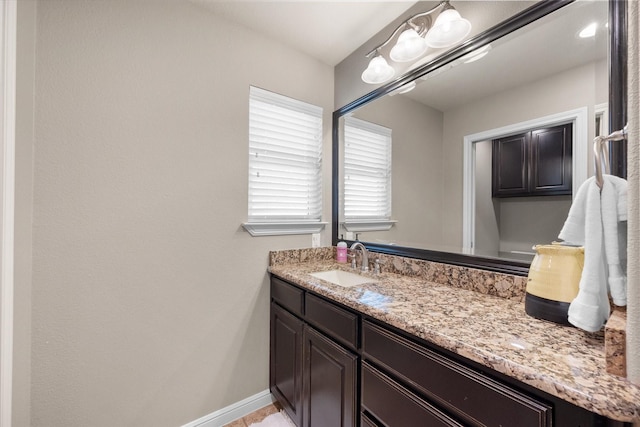 bathroom featuring vanity and baseboards