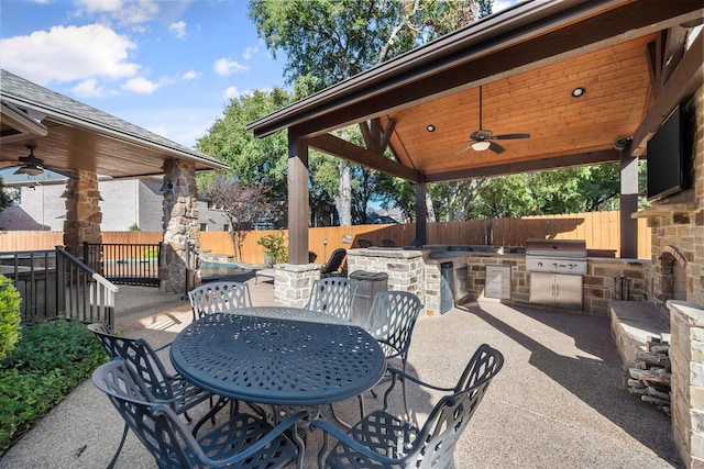 view of patio / terrace with a ceiling fan, an outdoor kitchen, outdoor dining area, a fenced backyard, and grilling area