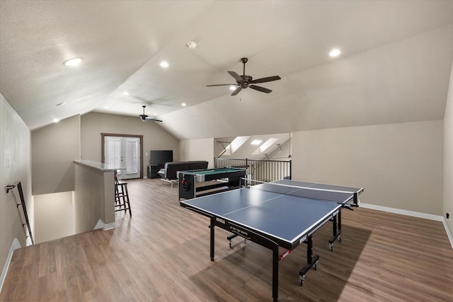 rec room with lofted ceiling, wood finished floors, a ceiling fan, and baseboards