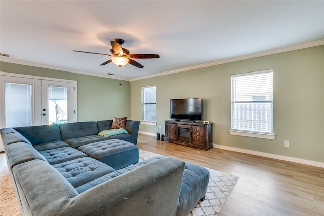 living room with crown molding, plenty of natural light, and french doors