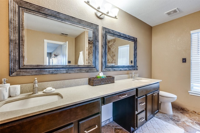 bathroom featuring a sink, visible vents, and double vanity