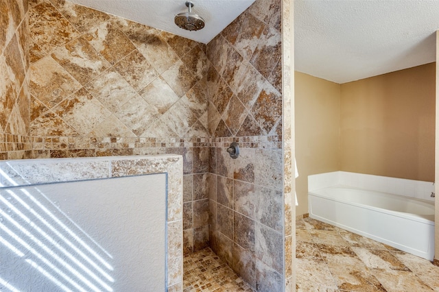 full bathroom featuring a textured ceiling, walk in shower, and a bath