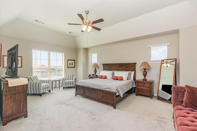 bedroom featuring visible vents, lofted ceiling, light colored carpet, and a ceiling fan