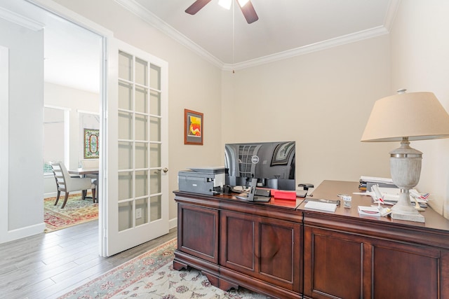 office space featuring a ceiling fan, baseboards, light wood finished floors, french doors, and crown molding