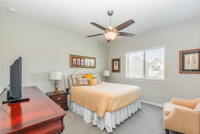 carpeted bedroom featuring a ceiling fan and baseboards