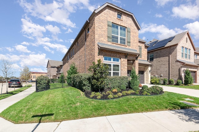 view of side of property featuring brick siding, an attached garage, driveway, and a lawn