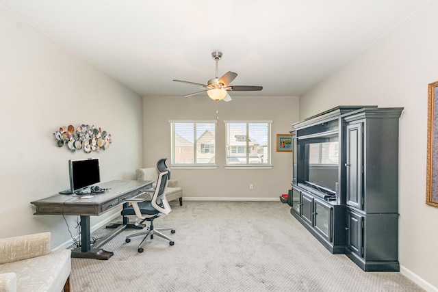 office featuring light carpet, ceiling fan, and baseboards