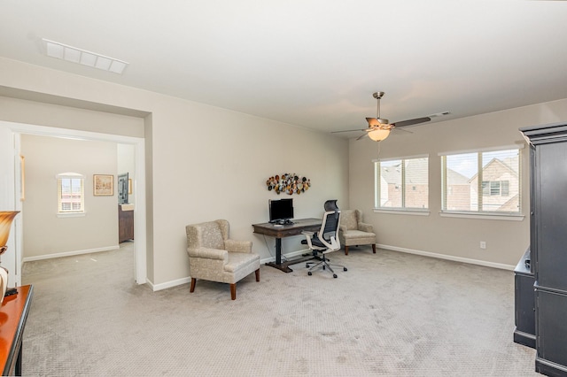 office area with visible vents, light colored carpet, and baseboards