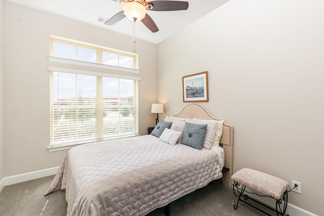 carpeted bedroom featuring baseboards and ceiling fan